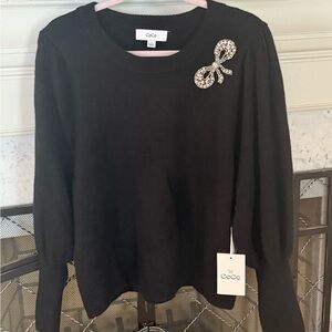CeCe Black Sweater beaded with a silver bow size L.  BNWT from Macy’s